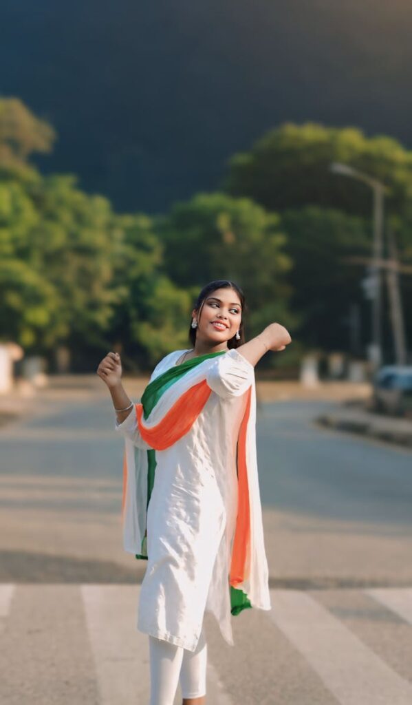A joyous young woman wearing traditional attire in Delhi, symbolizing national pride and cultural freedom.